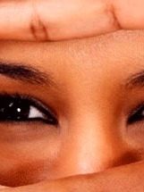 Primer plano de unos ojos expresivos con una mano en la frente.
